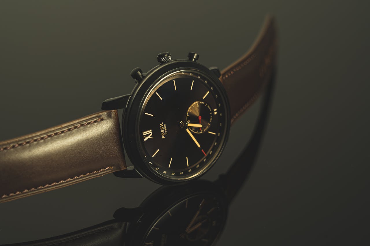 Luxurious black wristwatch with leather strap and analog display in close-up view.